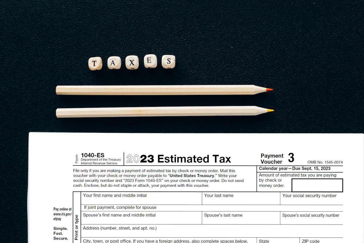 Form 1040-ES and a word taxes laid on a table