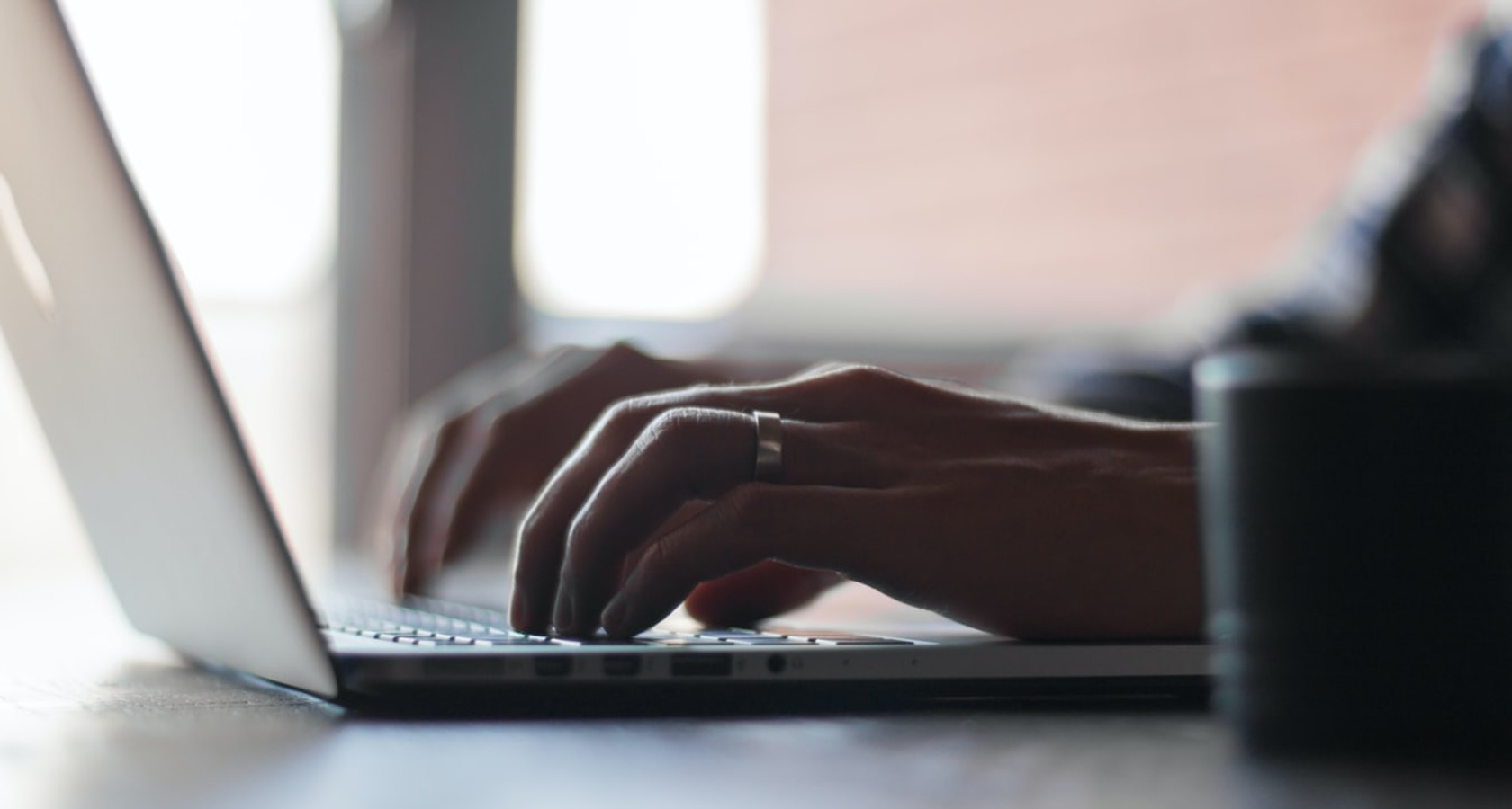 hands typing on a laptop