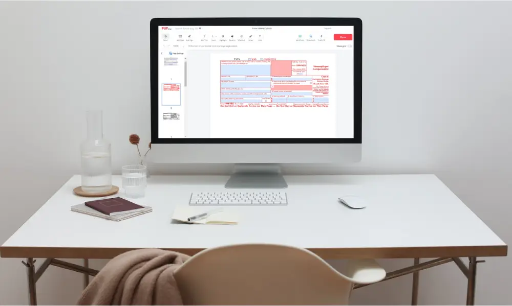 Worktable with form 1099-NEC on screen